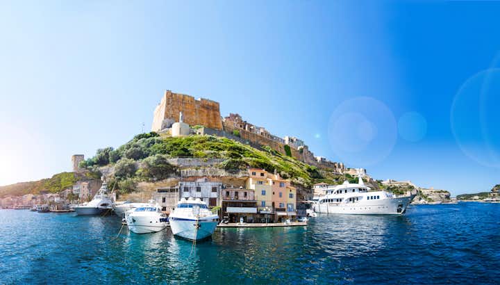 Panoramic view of the Bonifacio port, city, castle and yachts on a sunny summer day.