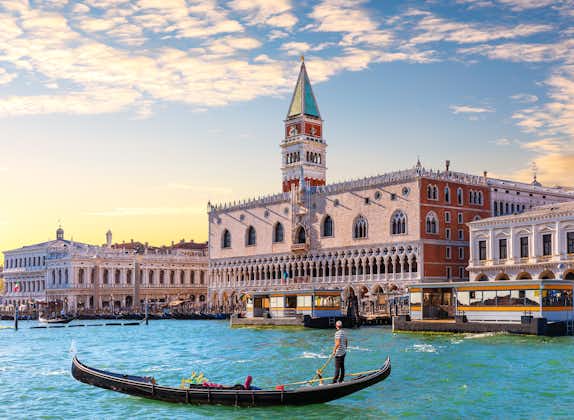 photo of Gondola in front of the Doge's Palace in Venice, Italy .