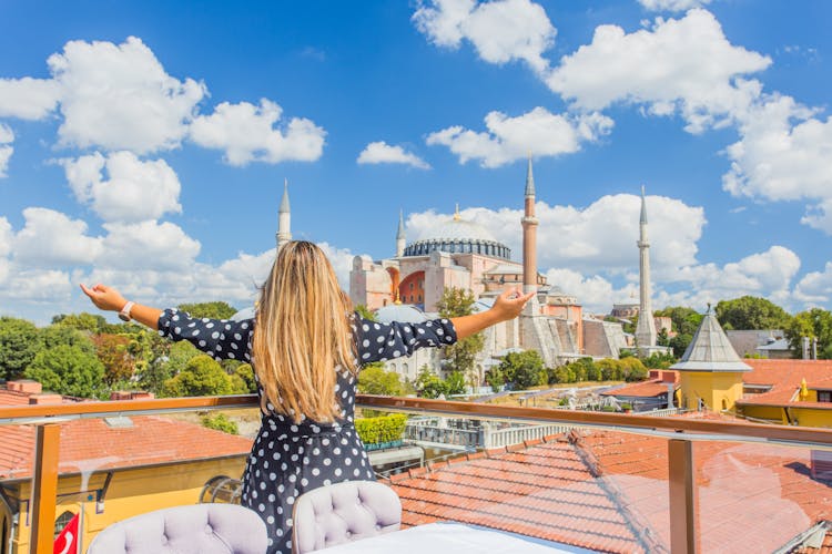 Photo of tourist and wonderful panoramic view of the city against the beautiful sky.