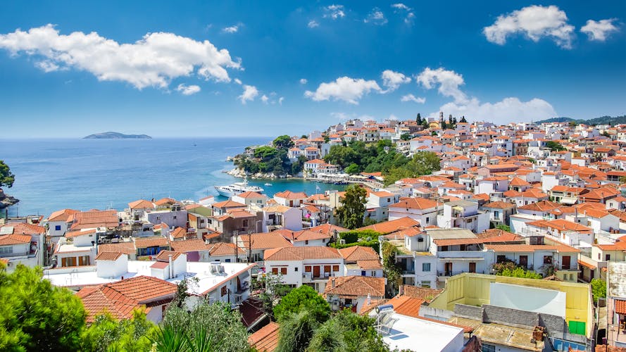 Photo of Skiathos town, beautiful view of the old town with boats in the harbor.