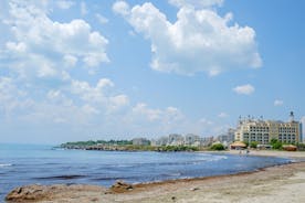 Photo of Saint Anastasia Island in Burgas bay, Black Sea, Bulgaria. Lighthouse tower and old wooden buildings on rocky coast.