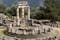 photo of view of Tholos at the sanctuary of Athena Pronaia, Delphi, Greece.