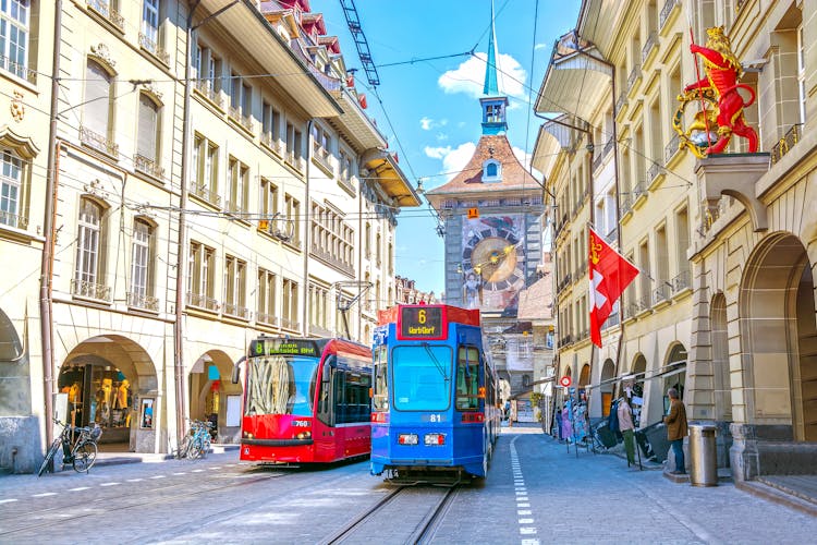 Photo of streets with shopping area and Zytglogge astronomical clock tower in the historic old medieval city centre of Bern, Switzerland.