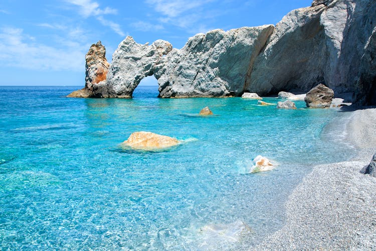 Photo of the famous rock with a hole in Lalaria Beach, Skiathos.