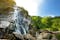 Majestic water cascade of Powerscourt Waterfall, the highest waterfall in Ireland. Famous tourist atractions in co. Wicklow, Ireland.