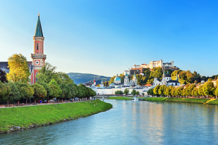 Photo of beautiful view of Salzburg skyline with Festung Hohensalzburg and Salzach river in summer.