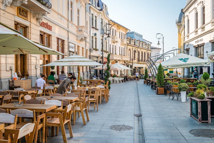 Photo of People are sitting in cafes on Alexandru Ioan Cuza street in Craiova, Romania.