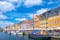 Photo of Scenic summer view of Nyhavn pier with colorful buildings and boats in Old Town of Copenhagen, Denmark.