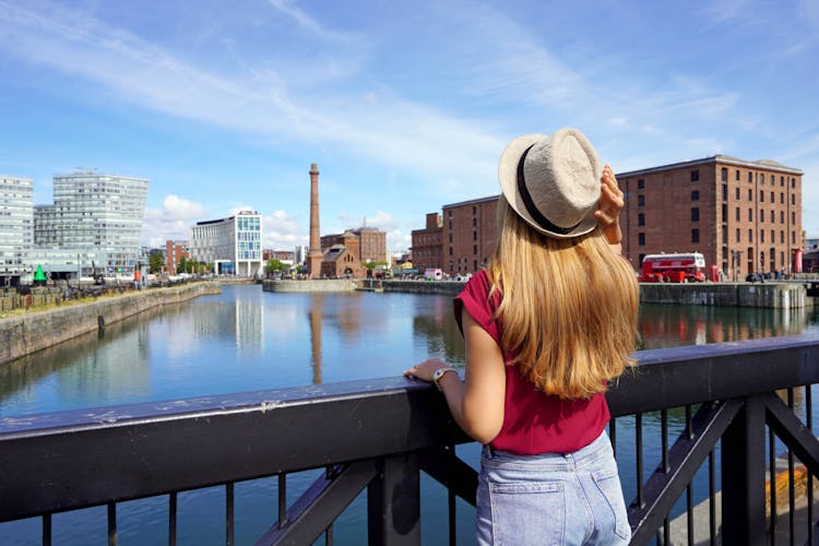 Photo of tourist girl on Swing Bridge visiting the Royal Albert Dock in Liverpool, England.