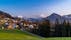 Photo of Dornbirn at sunset with a view of the meadows, forests and snowy mountains in background, Austria.