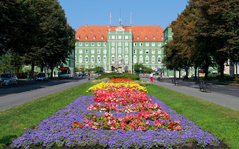 Photo of vibrant gardens leading up to the City Council of Szczecin.