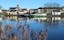 Photo of Carrick-on-Shannon, County Leitrim, Ireland viewed from across River Shannon against backdrop of blue sky.
