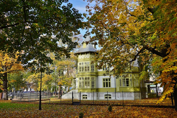 Photo of old green wooden house in skansen in Lodz.