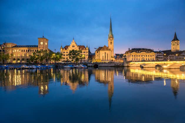 photo of Zurich cityscape at night with Fraumünster church and Limmat, Canton Zürich, Switzerland.