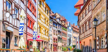 Photo of scenic summer view of the German traditional medieval half-timbered Old Town architecture and bridge over Pegnitz river in Nuremberg, Germany.