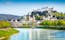 Photo of beautiful view of Salzburg skyline with Festung Hohensalzburg and Salzach river in summer, Salzburg, Salzburger Land, Austria.