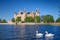 View of the Schwerin medieval castle from the lake with swans, Germany.