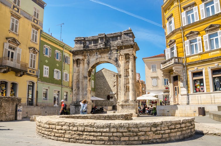 Photo of ancient Roman triumphal arch or Golden Gate and square in Pula.