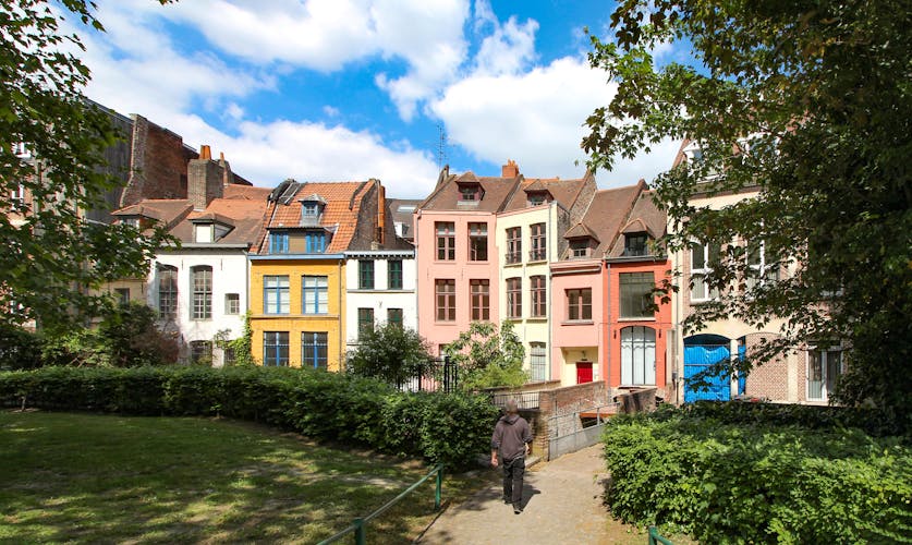 Photo of Row of old colorful houses in Place Gilleson behind Notre-Dame de la Treille Cathedral in Lille, France.