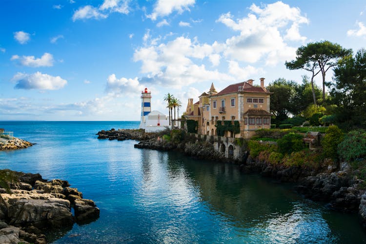 Photo of beautiful view of Cascais ,coastal resort and fishing town, with Santa Maria House and Lighthouse , Portugal.