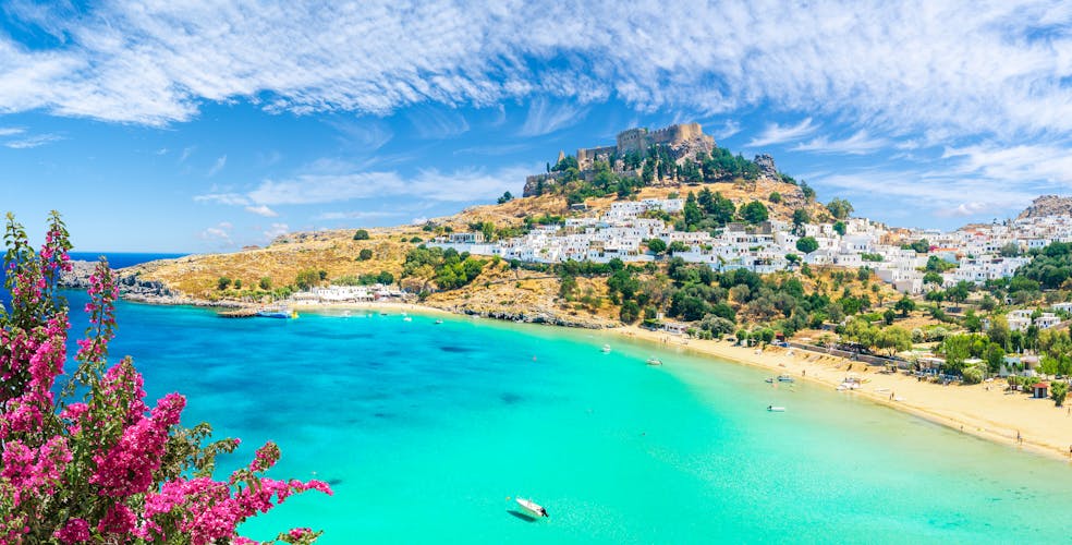 Photo of landscape with beach and castle at Lindos village of Rhodes, Greece.