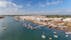 Photo of aerial view of pier fishing boats in the village Cabanas de Tavira, Portugal.