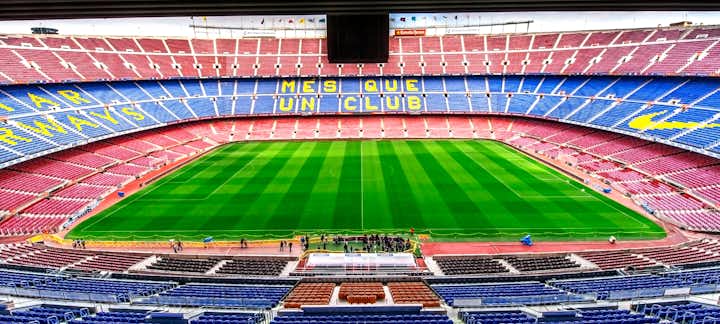 Photo of view on the field and the tribunes at Camp Nou arena.