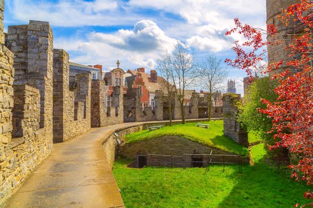 Photo of inner yard of Gravensteen castle or Castle of the Counts, spring trees panorama, Belgium.