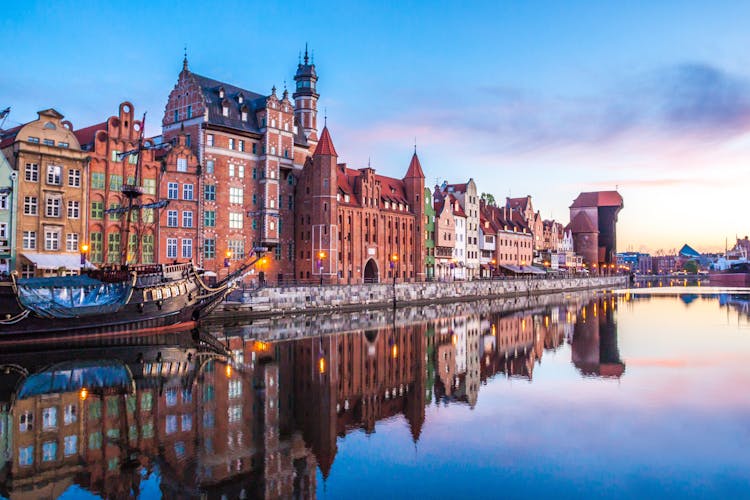 Photo of panorama of the facades of old medieval houses on the promenade in Gdansk.
