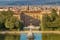 photo of The Boboli Gardens park, Fountain of Neptune and a distant view on The Palazzo Pitti, in English sometimes called the Pitti Palace, in Florence, Italy. Popular tourist attraction and destination.
