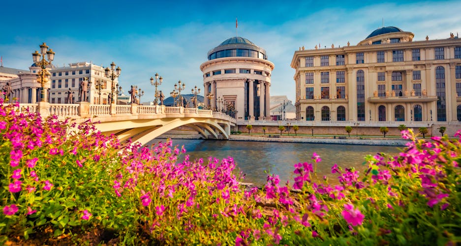 Photo of flowers on the shore of Vardar river. Exciting spring cityscape of capital of North Macedonia - Skopje with Archaeological Museum.