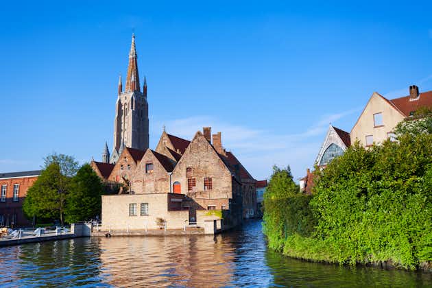 Photo of sunny view of Church of Our Lady Bruges view from river, Belgium.