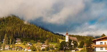 photo of beautiful alpine summer view with a church at Waidring, Tyrol, Austria.
