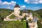 Photo of aerial view to The Karlstejn castle. Royal palace founded King Charles IV. Amazing gothic monument in Czech Republic.