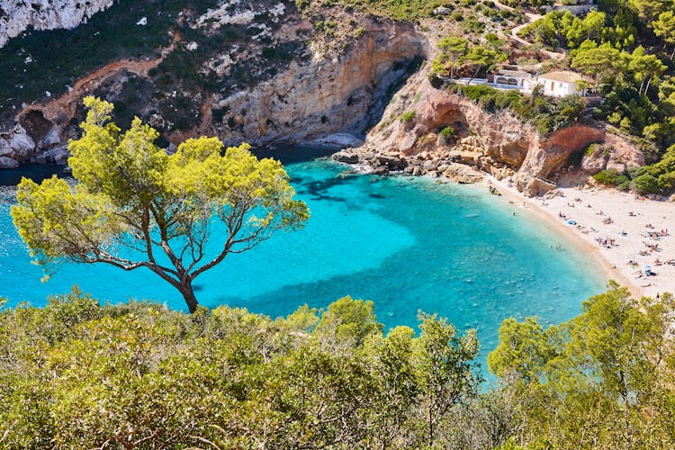 Photo of Spanish mediterranean sunny scenic coastline. La Granadella beach. Alicante, Valencia.