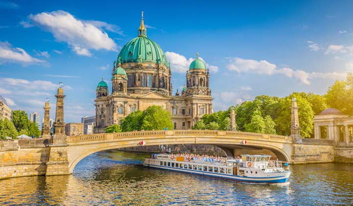 beautiful view of historic Berlin Cathedral (Berliner Dom) at famous Museumsinsel (Museum Island) with excursion boat on Spree river in beautiful sunset in summer, Berlin.
