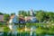 Photo of beautiful old town houses and church panorama with lake reflection in summer morning in Talsi, Latvia.