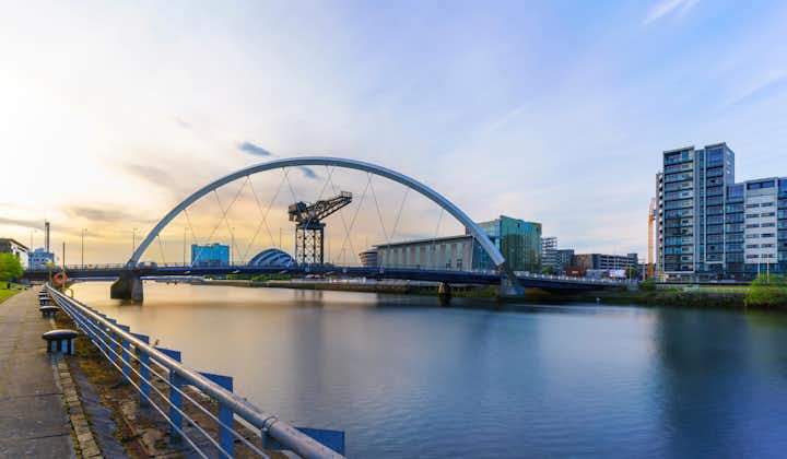Photo of the Clyde Arc Bridge or the Squinty Bridge crossing the river Clyde in twilight in Glasgow , Scotland , UK.