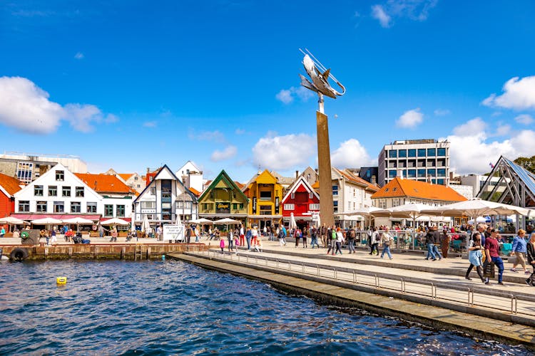 Photo of lots of tourists walking, shopping and sightseeing city center in Stavanger, Norway.