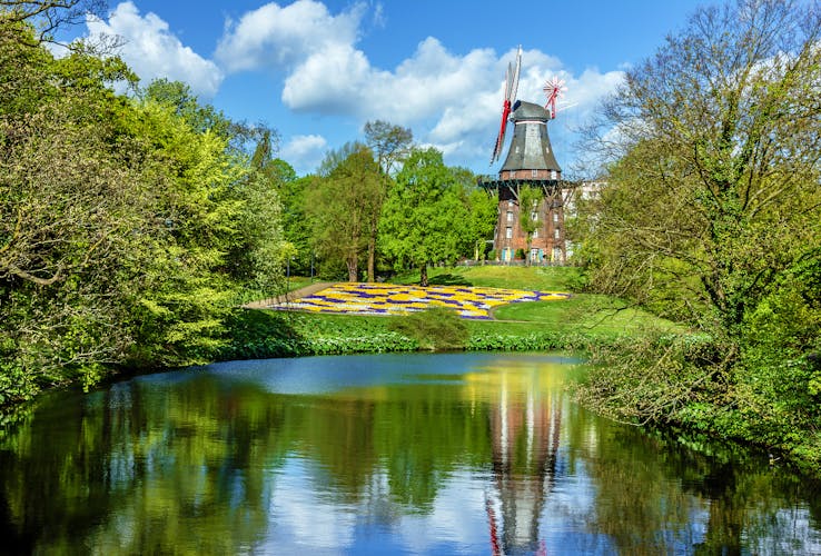 Photo of Mill in green park and lake, Bremen, Germany.