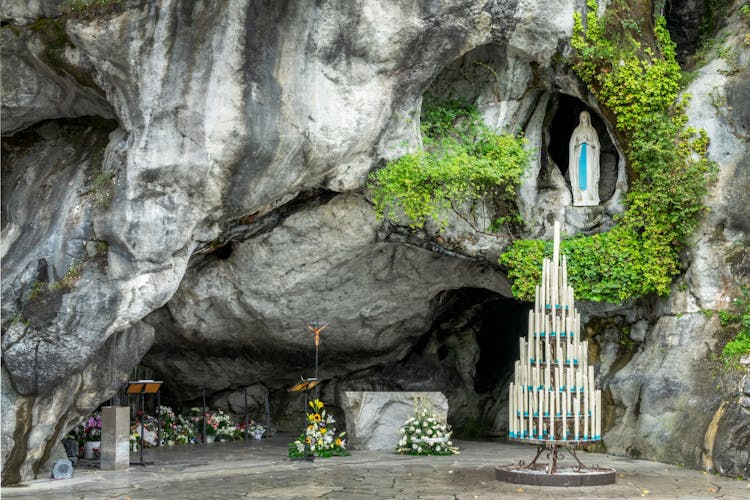 Photo of statue of Virgin Mary in the grotto of Lady of Lourdes, France.
