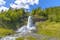 Photo of splendid summer view with popular waterfall Steinsdalsfossen on the Fosselva River, municipality of Kvam in Hordaland county, Norway.