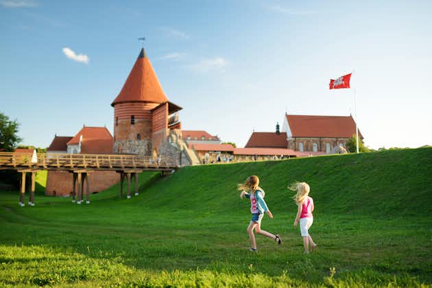 photo of two kids playing near kaunas castle, originally built during the mid-14th century, situated in kaunas, Lithuania.