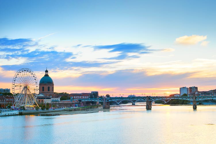 Photo of Toulouse landmarks on the bank of river Garone at sunset. France.