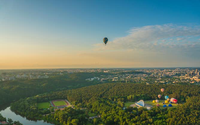 photo of aerial view of Vilnius, Lithuania - July 6, 2020: Hot air balloons taking off from vingis park in Vilnius city on summer morning.