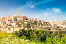 Photo of panoramic view of the ancient town of Matera (Sassi di Matera), European Capital of Culture 2019, in beautiful golden morning light with blue sky and clouds, Basilicata, southern Italy.