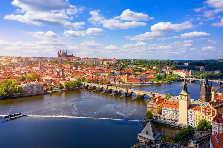 Photo of scenic view of the Old Town pier architecture and Charles Bridge over Vltava river in Prague.