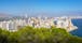 photo of panorama of the towns and Tossal de la Cala from a hill in a natural park in Benidorm, Valencia, Spain.