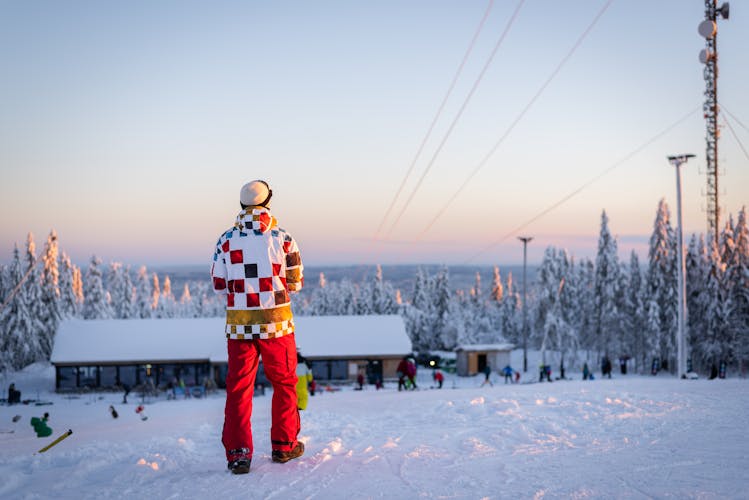 photo of skier/snowboarder in Oslo winter park during winter holidays at sunset in Norway.