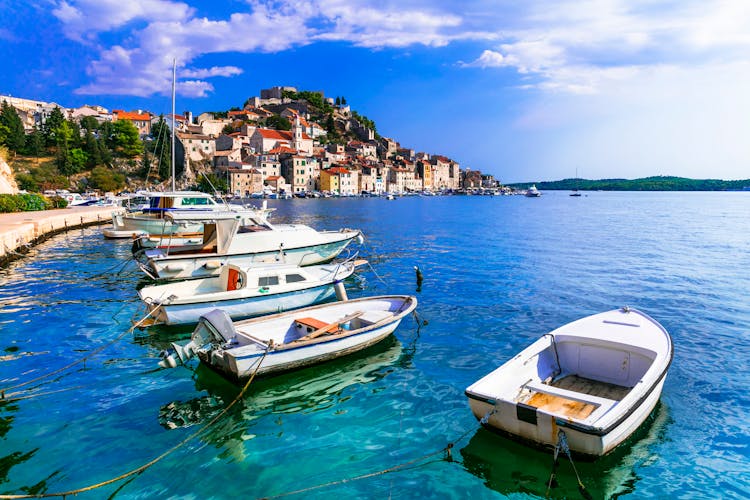 Photo of  magnificent medieval coastal town Sibenik with white boats in Dalmatia.